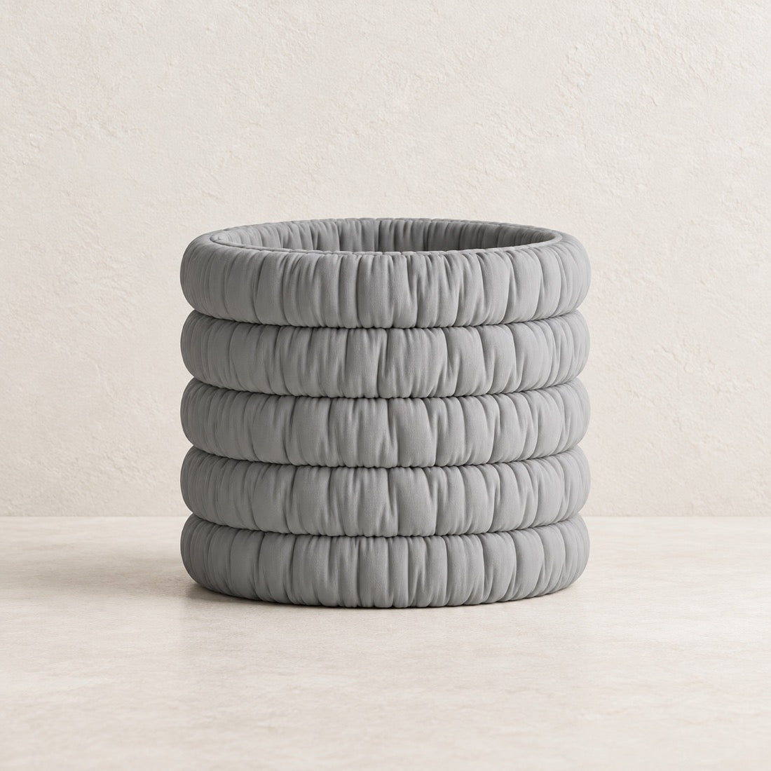 Mossmallow Planter in Gray (#A6A9AA), empty pot with warm plaster background and pale tabletop