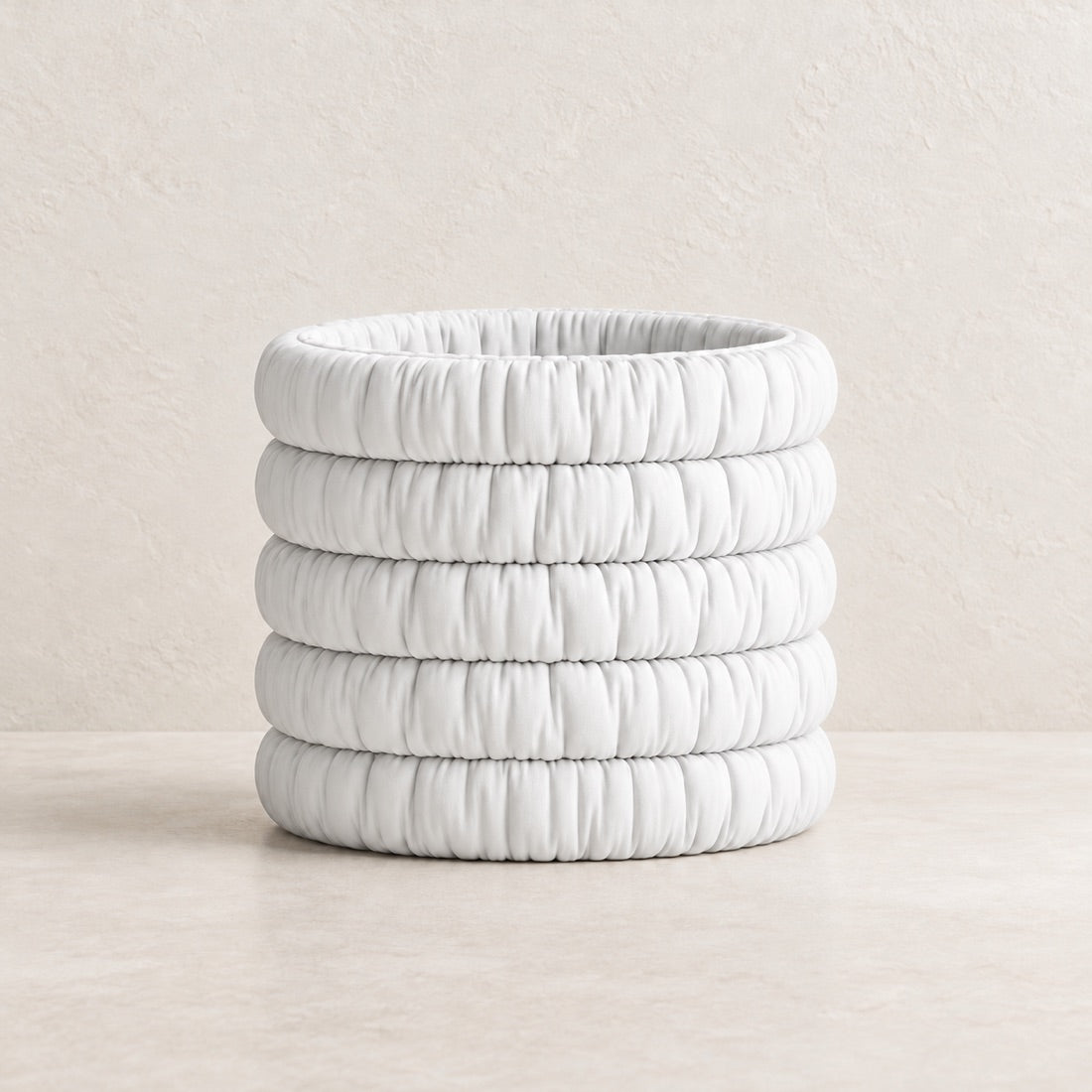 Mossmallow Planter in White (#FFFFFF), empty pot with warm plaster background and pale tabletop